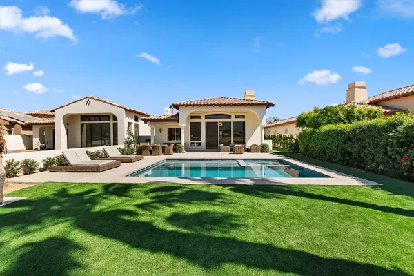 a house with swimming pool in front of it