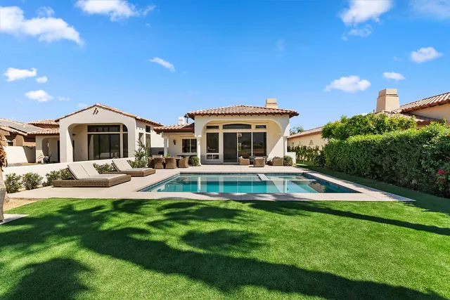 a house with swimming pool in front of it