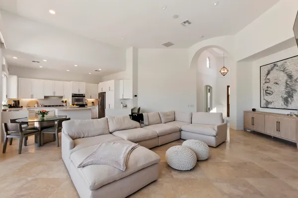 a living room with furniture and view of kitchen