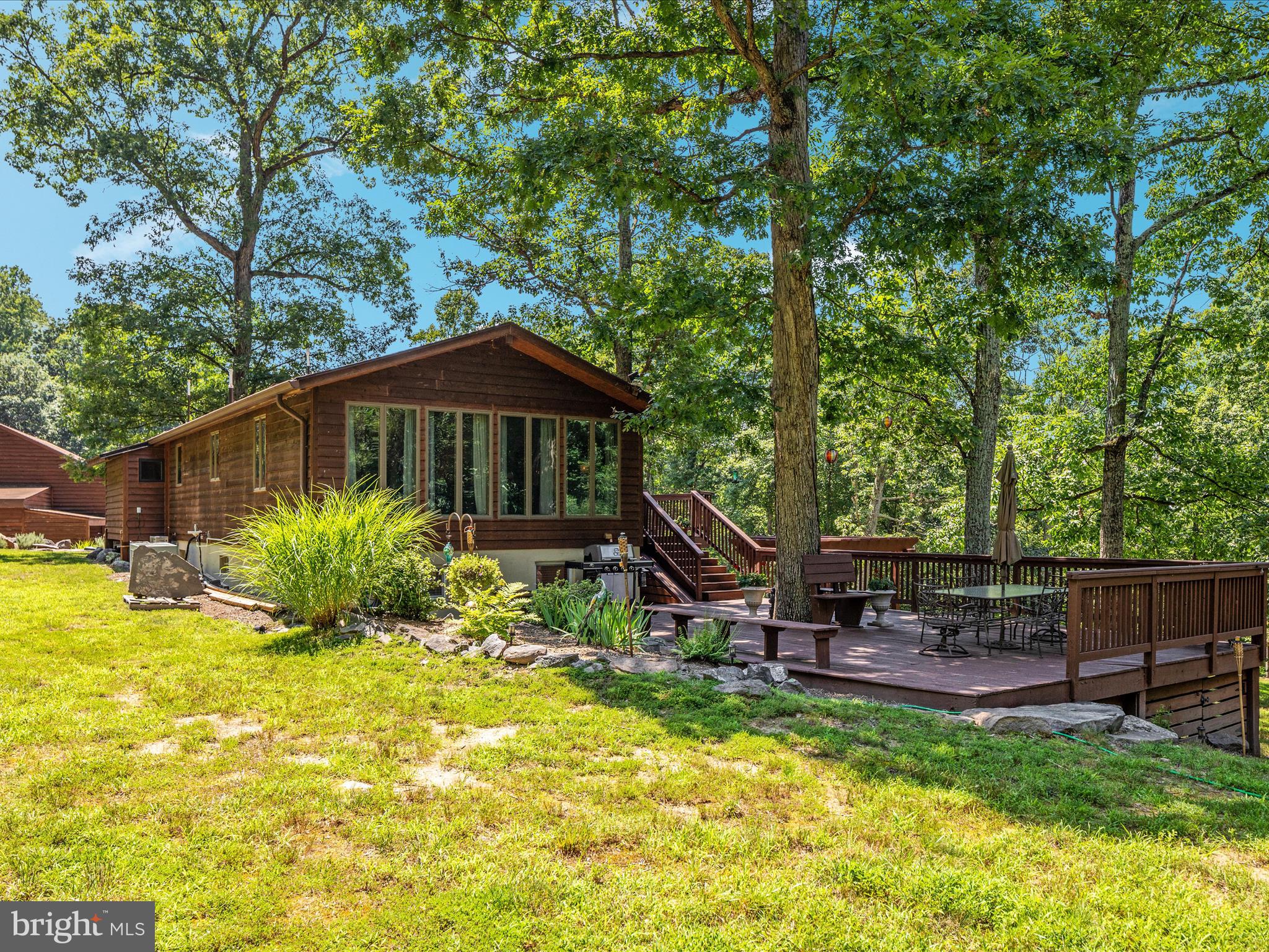 4327 Ebenezer Road Bluemont, VA 20135 - Photo 2 of 93 a backyard of a house with table and chairs