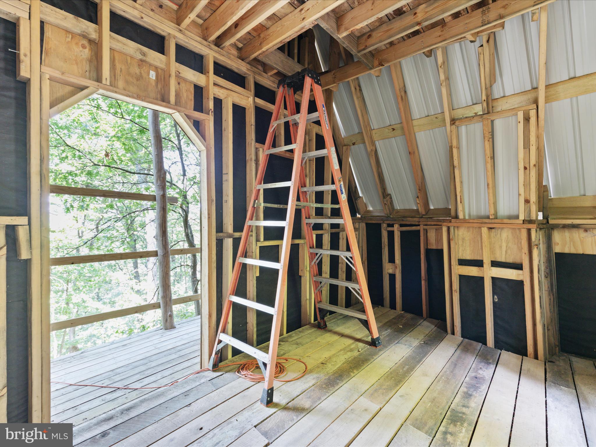 4327 Ebenezer Road Bluemont, VA 20135 - Photo 43 of 93 a view of walk in closet with wooden floor and windows