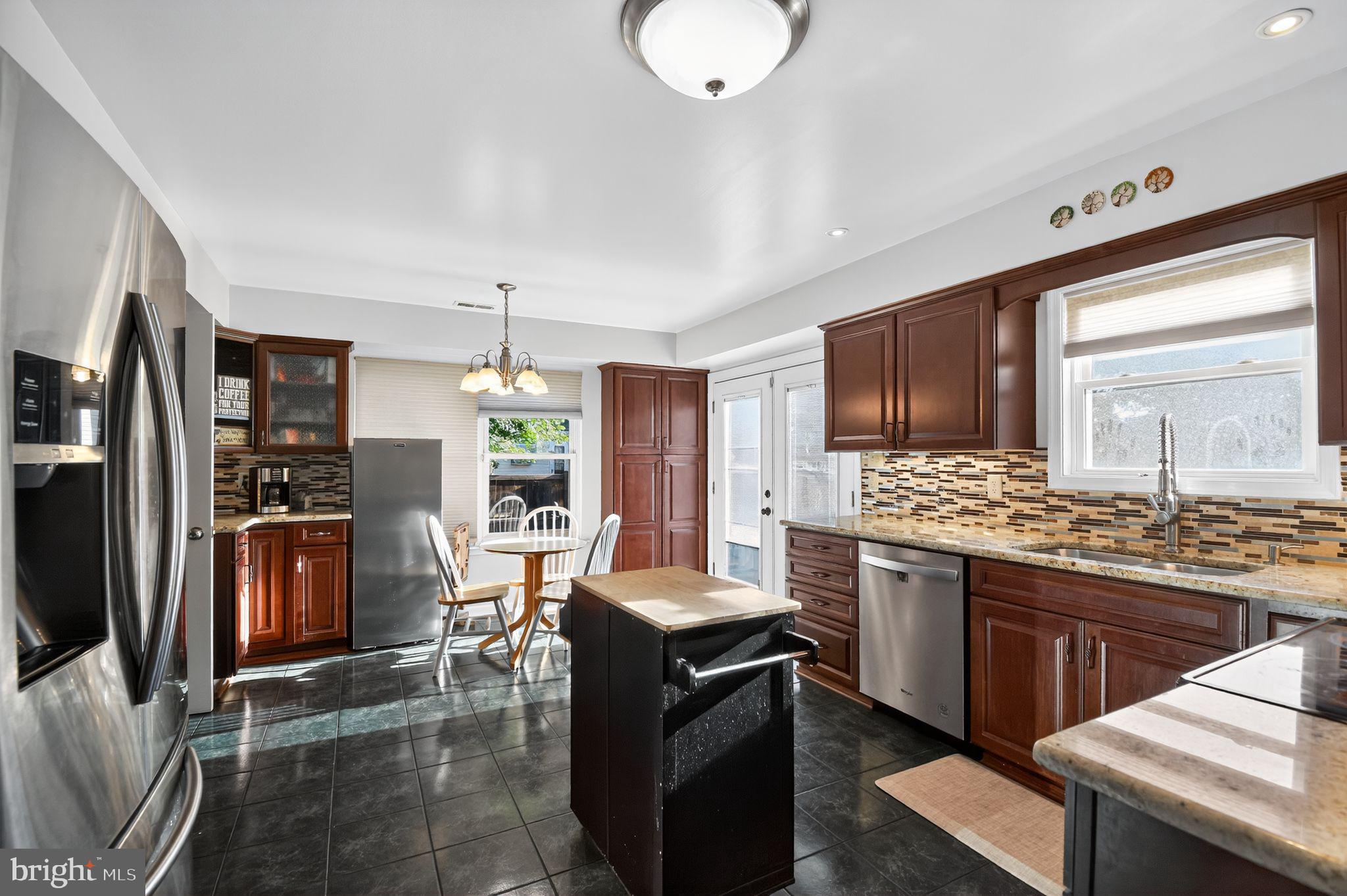 22040 Caravel Court Great Mills, MD 20634 - Photo 16 of 32 a kitchen with stainless steel appliances kitchen island granite countertop a stove refrigerator and cabinets