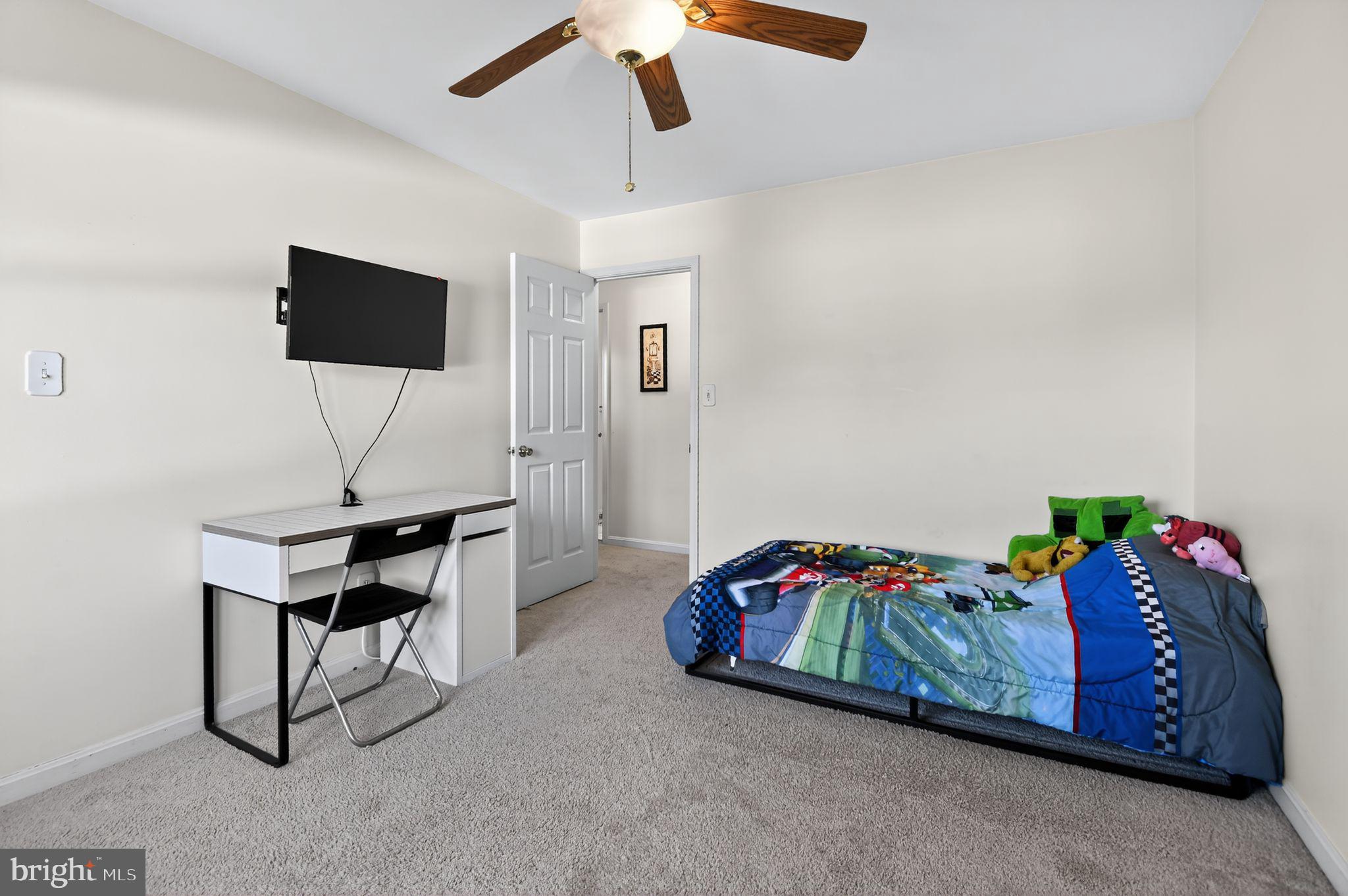 22040 Caravel Court Great Mills, MD 20634 - Photo 21 of 32 a bedroom with a bed and a flat screen tv