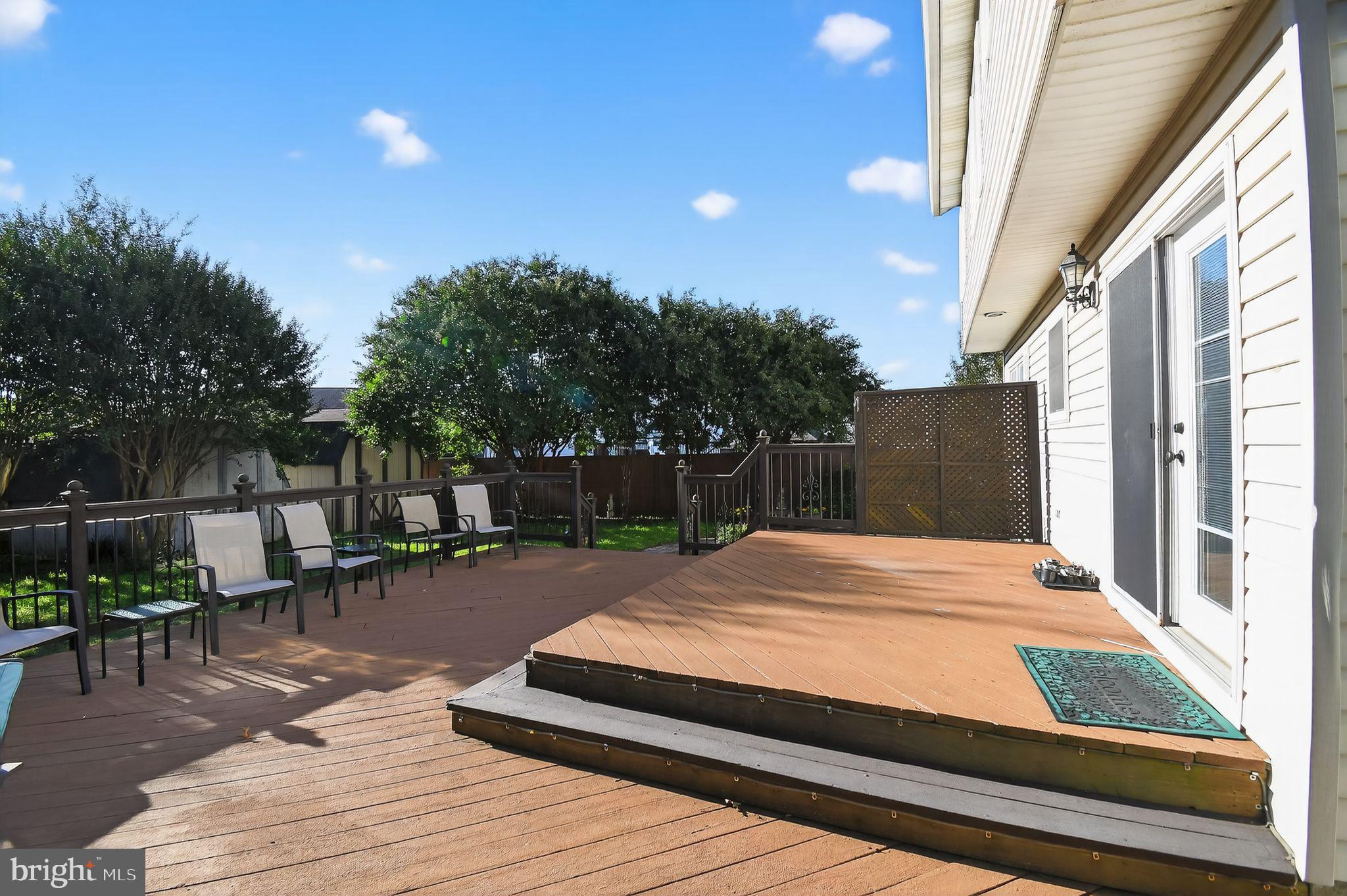 22040 Caravel Court Great Mills, MD 20634 - Photo 5 of 32 a patio with table and chairs and potted plants with wooden floor and fence