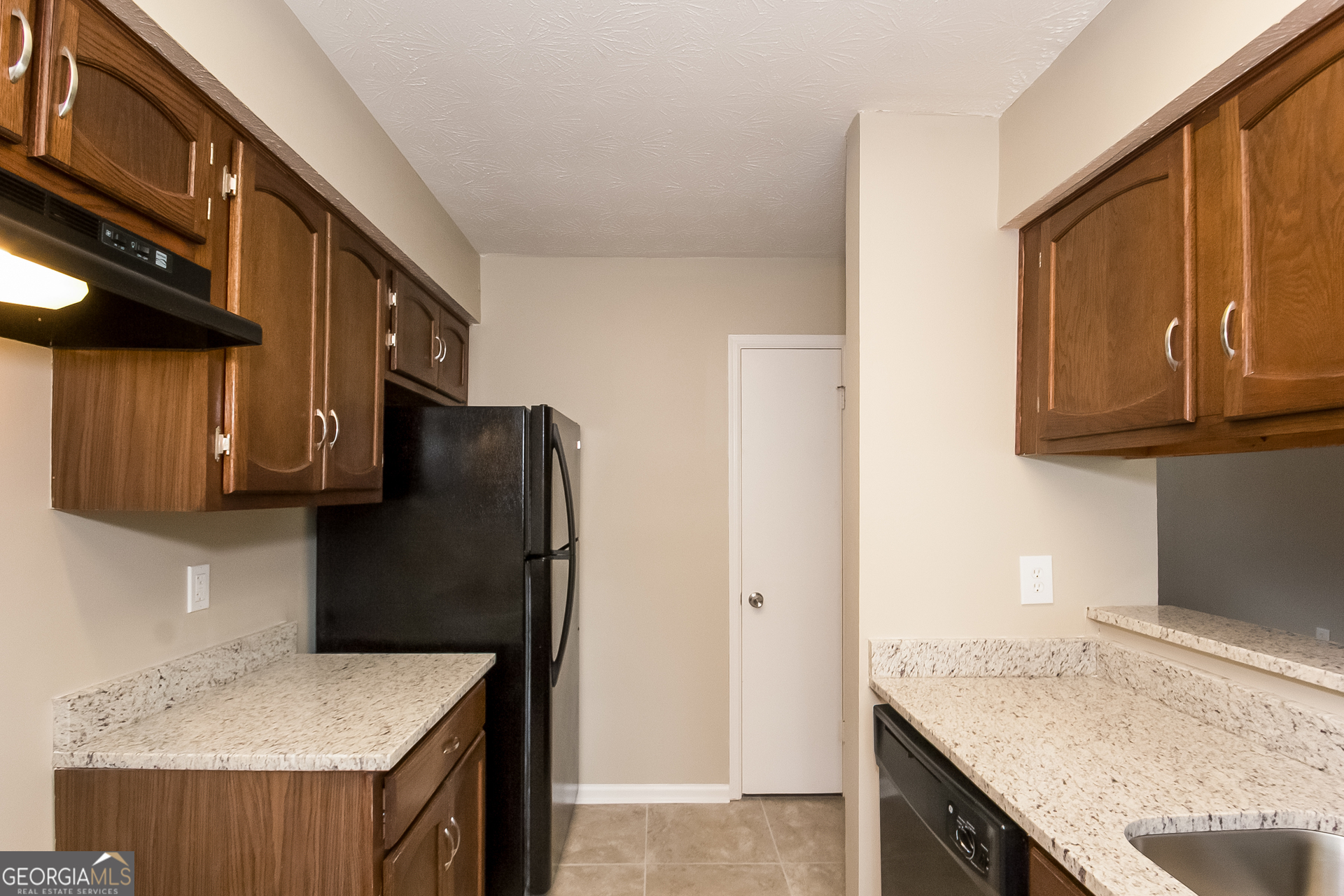606 Wilson Mill Road Southwest Atlanta, GA 30331 - Photo 7 of 15 a kitchen with stainless steel appliances granite countertop a refrigerator and a sink