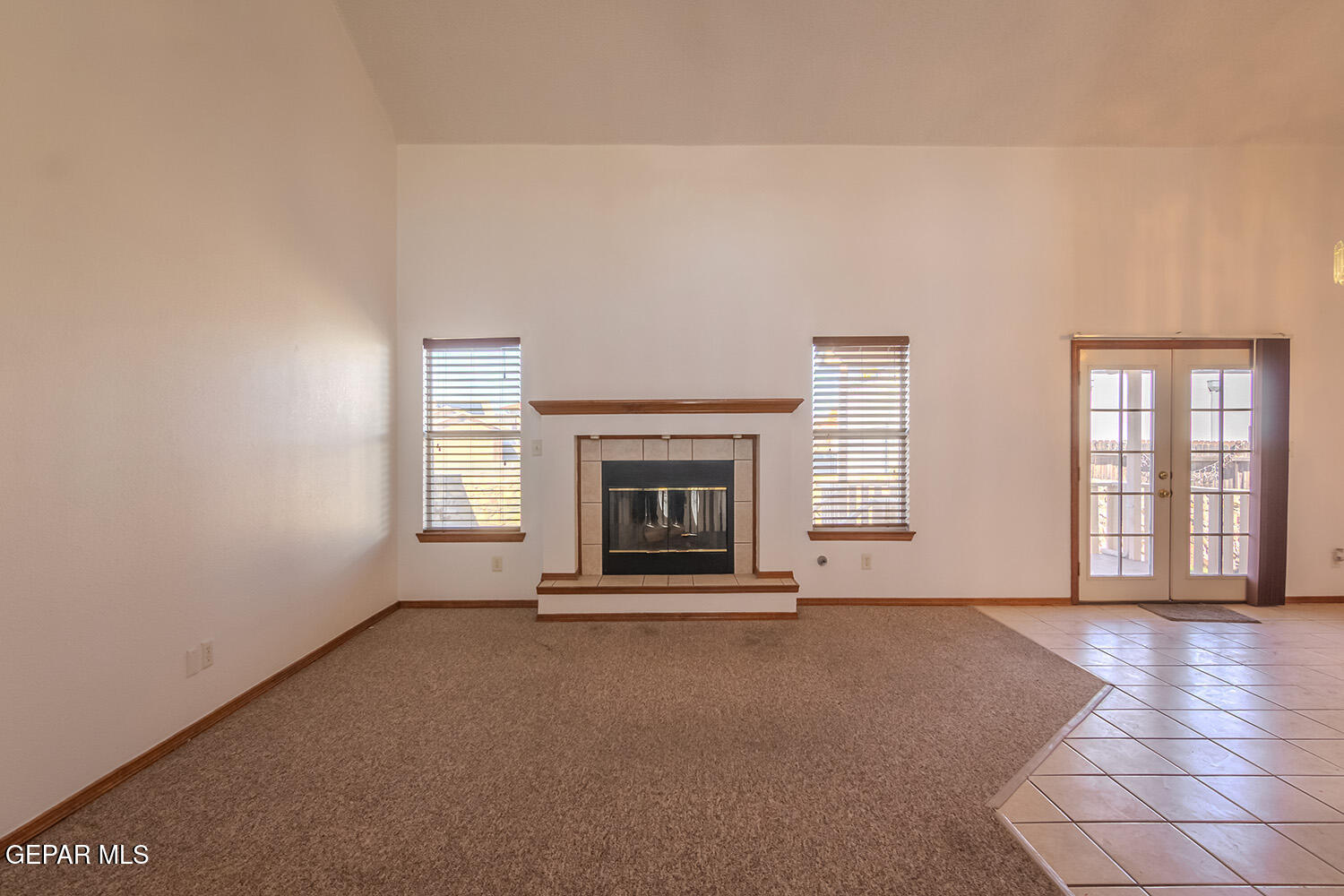 12259 Tierra Loma Road El Paso, TX 79938 - Photo 14 of 73 a view of an empty room with a fireplace and a window
