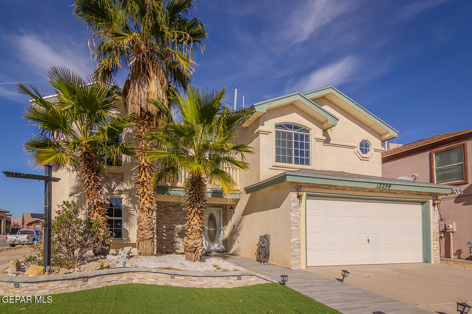 12259 Tierra Loma Road El Paso, TX 79938 - Photo 2 of 73 a front view of a house with a yard and garage
