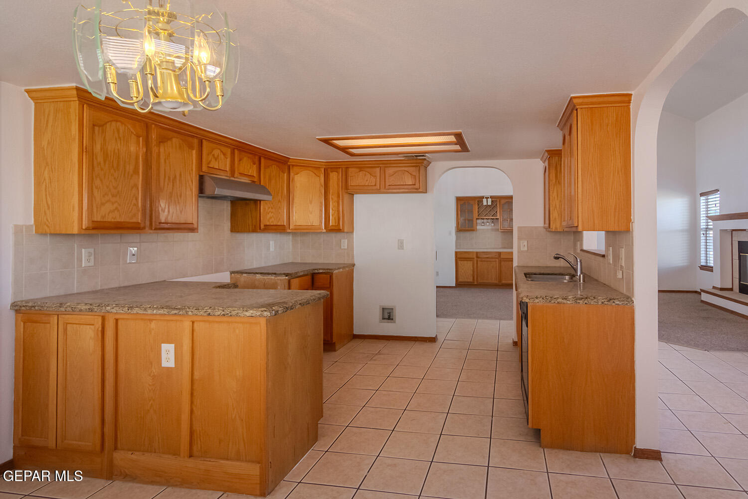 12259 Tierra Loma Road El Paso, TX 79938 - Photo 21 of 73 a kitchen with a sink a stove and cabinets