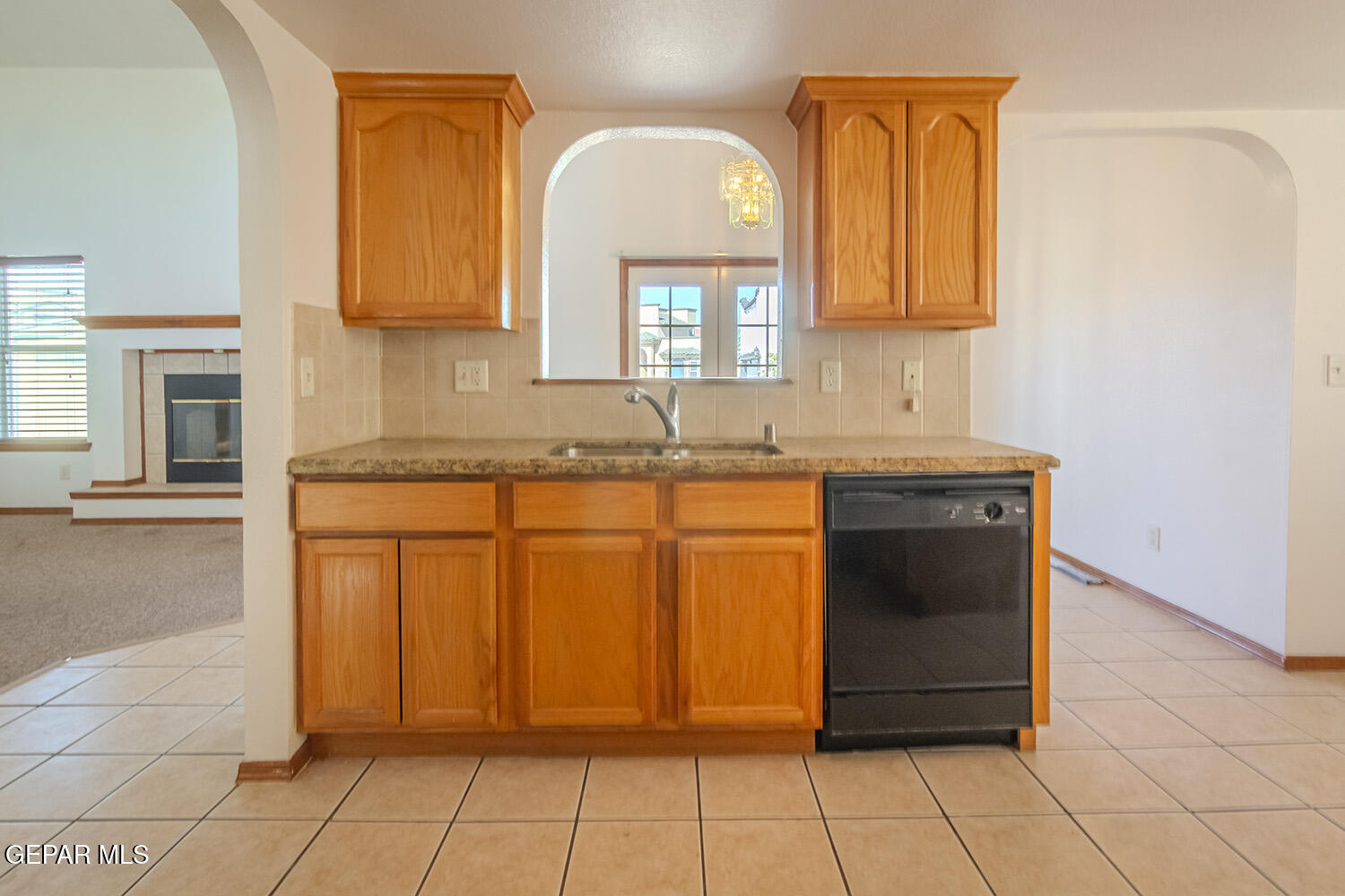 12259 Tierra Loma Road El Paso, TX 79938 - Photo 24 of 73 a bathroom with a granite countertop sink a mirror and vanity