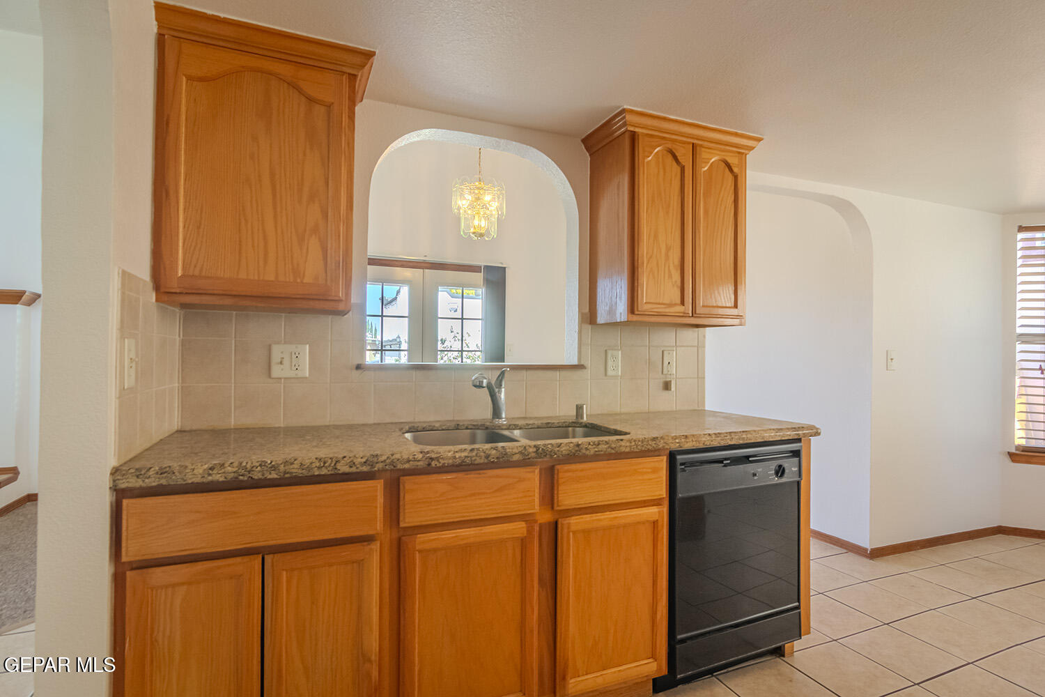 12259 Tierra Loma Road El Paso, TX 79938 - Photo 25 of 73 a kitchen with granite countertop cabinets sink and window