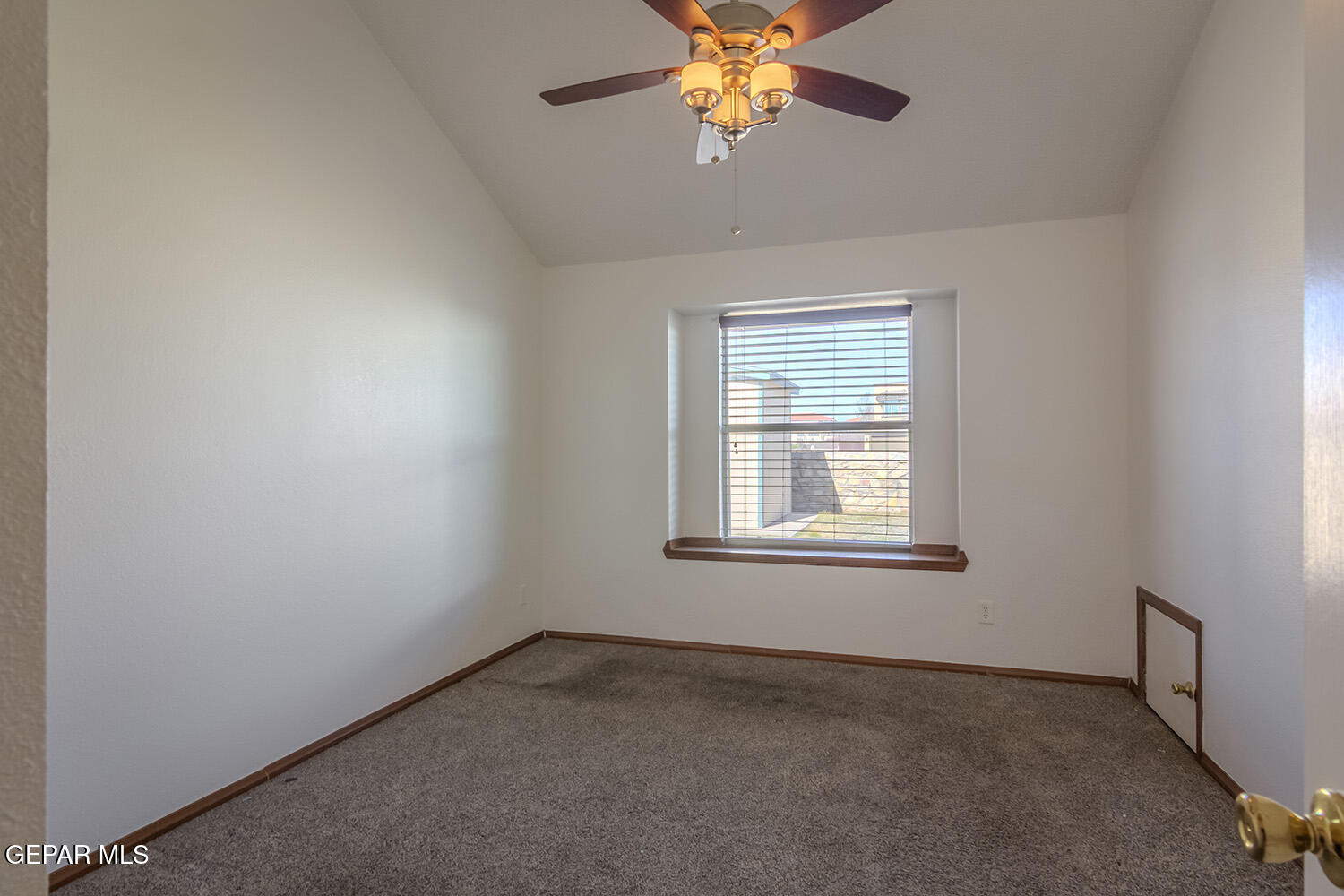 12259 Tierra Loma Road El Paso, TX 79938 - Photo 32 of 73 an empty room with a chandelier fan and windows