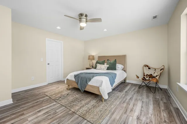 a bedroom with a bed and wooden floor