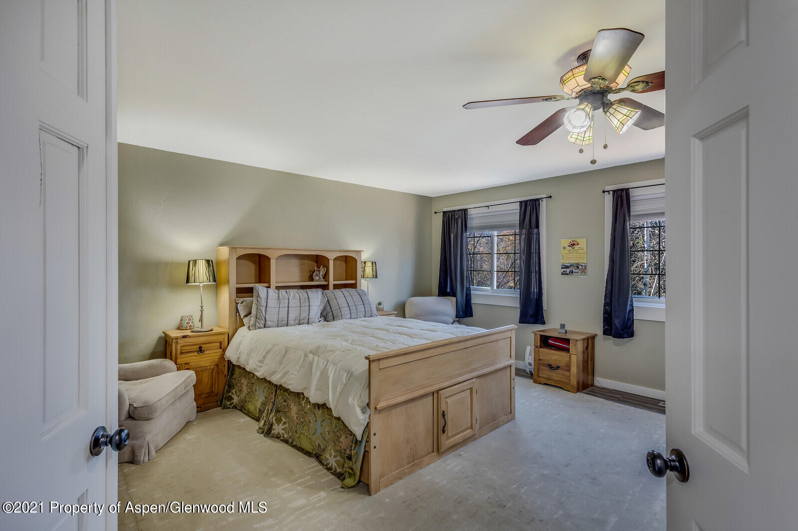 265 Badger Road El Jebel, CO 81623 - Photo 11 of 27 a bedroom with a bed and a chandelier