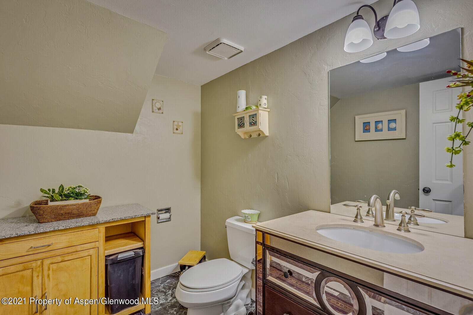 265 Badger Road El Jebel, CO 81623 - Photo 16 of 27 a bathroom with a granite countertop toilet sink and mirror