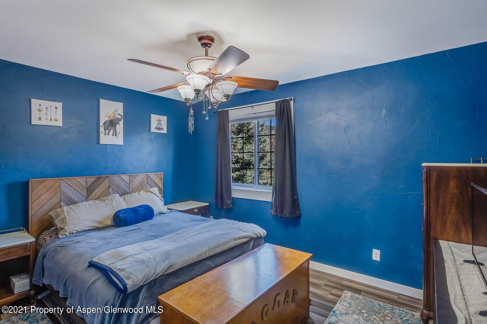 265 Badger Road El Jebel, CO 81623 - Photo 17 of 27 a bedroom with a bed and a chandelier