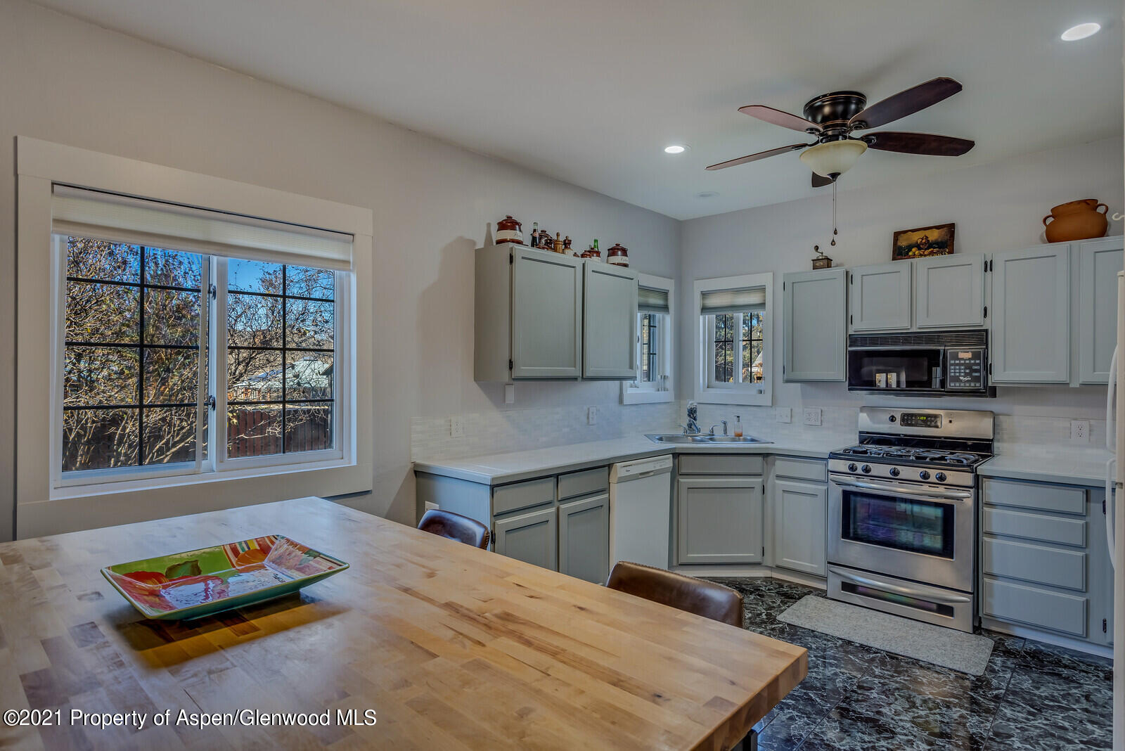 265 Badger Road El Jebel, CO 81623 - Photo 7 of 27 a kitchen with stainless steel appliances kitchen island granite countertop a sink dishwasher stove and refrigerator with wooden floor
