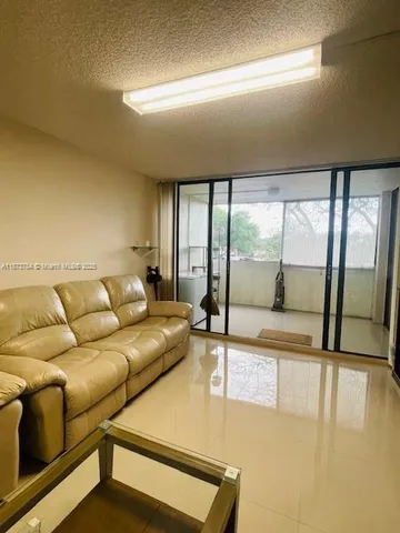 a living room with couch and a large window