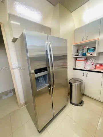a kitchen with a refrigerator and washer