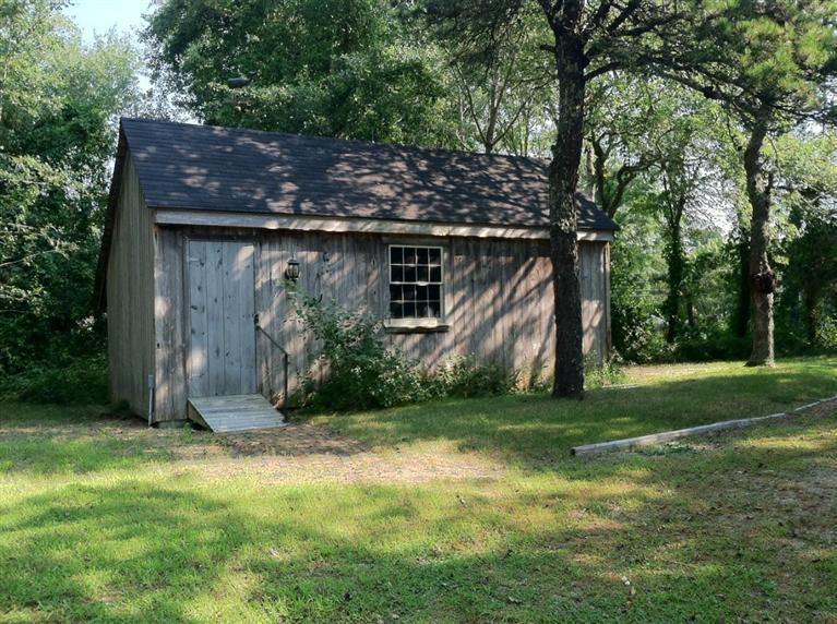 87 Chatham Road Harwich, MA 02645 - Photo 14 of 15 a view of a wooden house with a big yard and large trees