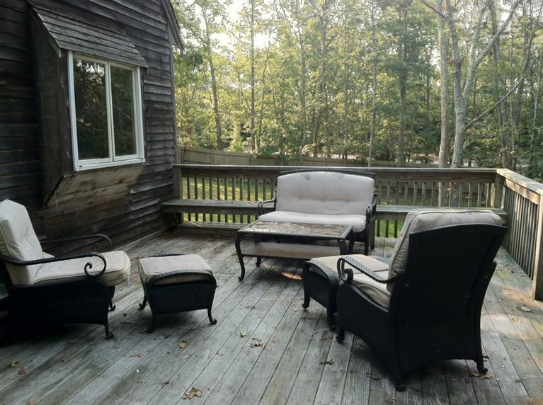 87 Chatham Road Harwich, MA 02645 - Photo 15 of 15 a view of a deck with chairs a barbeque grill with wooden floor and fence