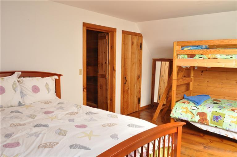 87 Chatham Road Harwich, MA 02645 - Photo 10 of 15 a bedroom with a bed and a dresser next to a window