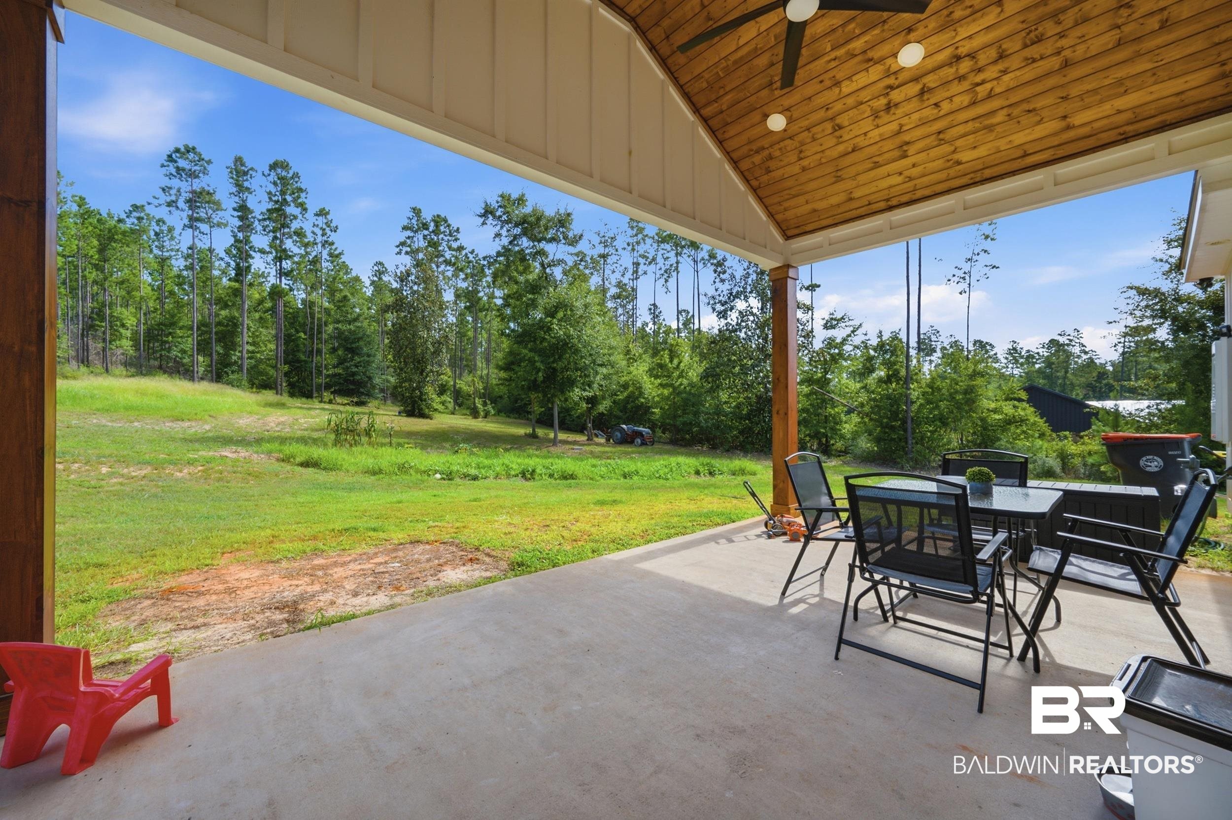 12019 Red Hill Rd Extension Bay Minette, AL 36507 - Photo 10 of 48 Expansive covered patio featuring a wood-plank ceiling, ceiling fan, and concrete flooring