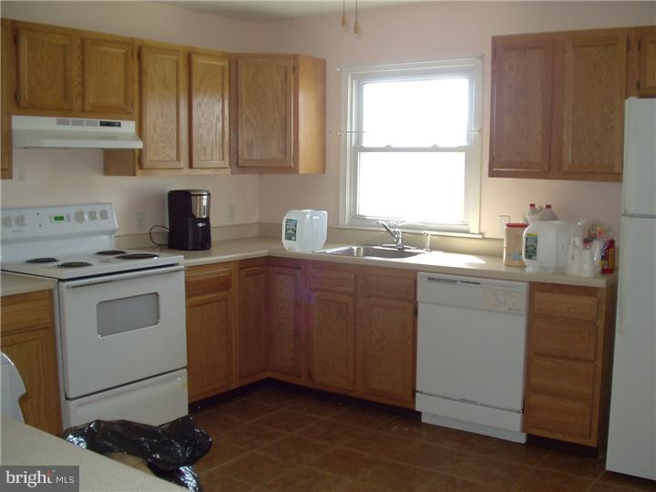 2306 Porter Road Bear, DE 19701 - Photo 9 of 9 a kitchen with stainless steel appliances granite countertop a sink stove cabinets and a window