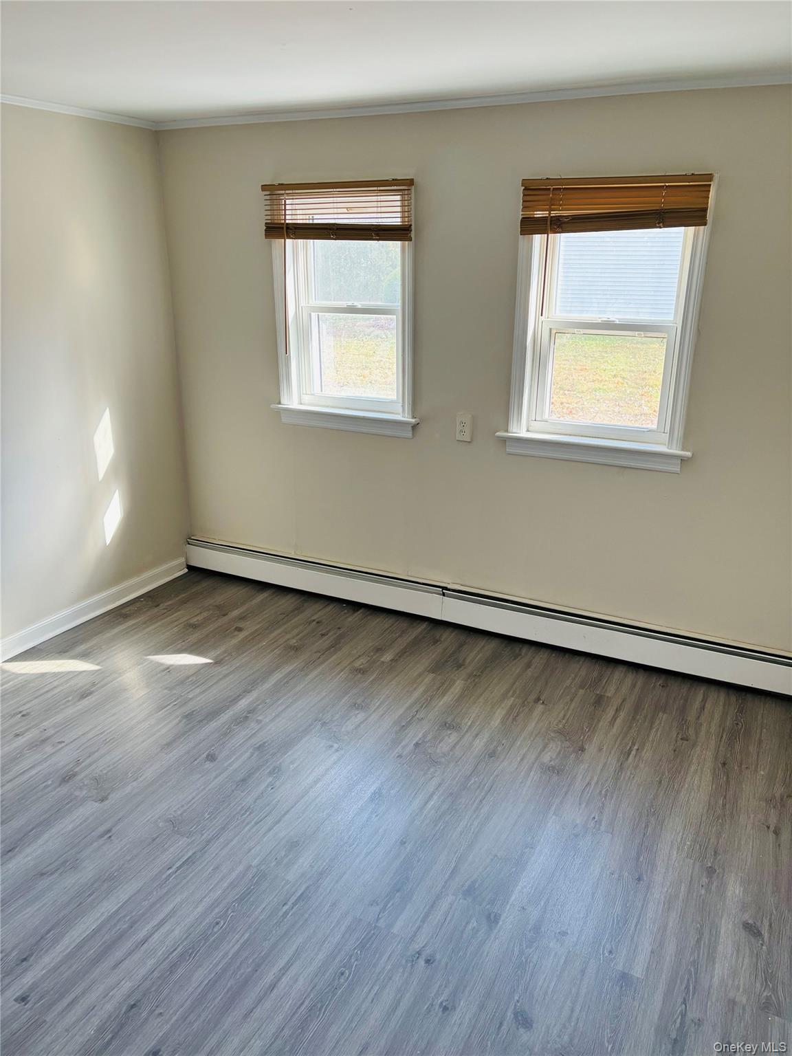 97 Holloran Road, Unit 1 New Windsor, NY 12553 - Photo 6 of 8 a view of an empty room with wooden floor and a window
