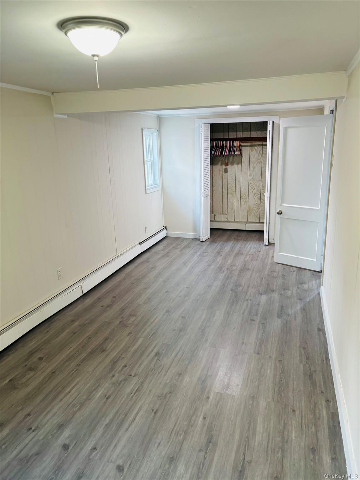 97 Holloran Road, Unit 1 New Windsor, NY 12553 - Photo 7 of 8 a view of empty room with wooden floor and entryway