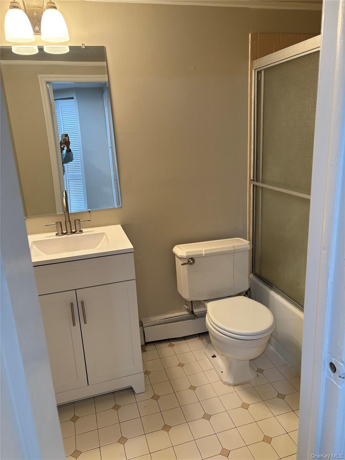 97 Holloran Road, Unit 1 New Windsor, NY 12553 - Photo 8 of 8 a bathroom with a toilet sink and mirror
