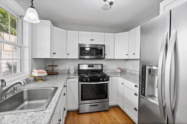 a kitchen with a sink cabinets and stainless steel appliances