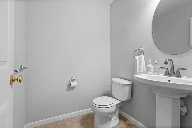 a bathroom with a sink mirror and toilet