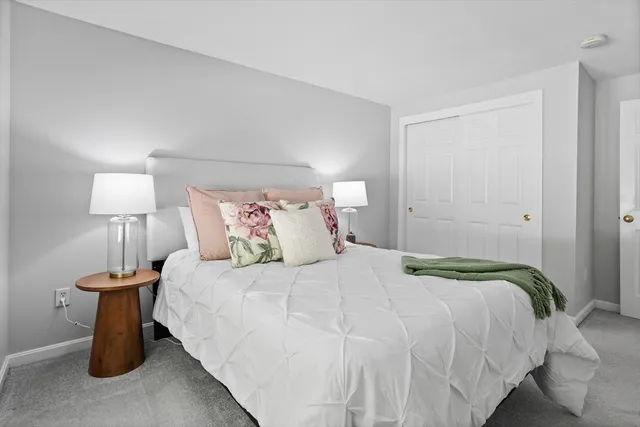 a bedroom with a bed and a lamp