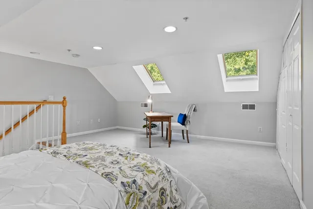 a bedroom with a bed and a chair