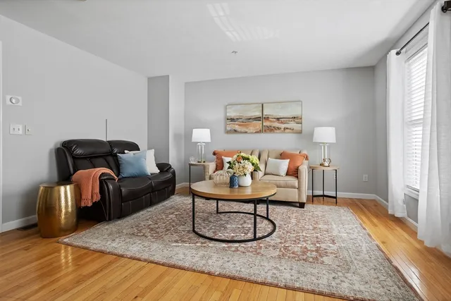 a bedroom with furniture and a rug