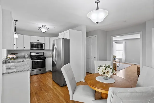 a view of kitchen with dining table and chairs