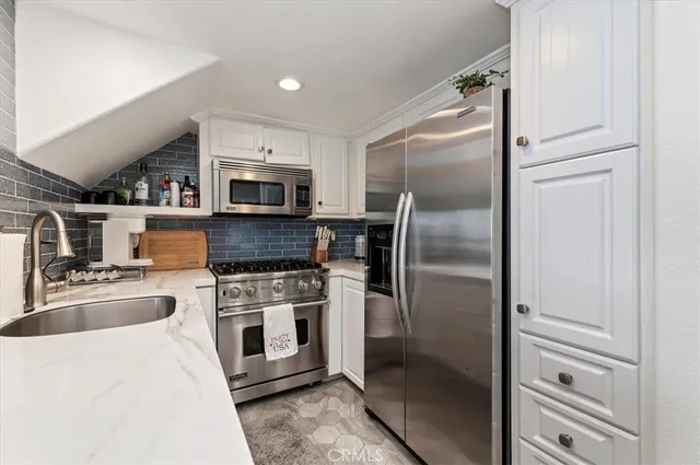 a kitchen with a refrigerator stove and microwave