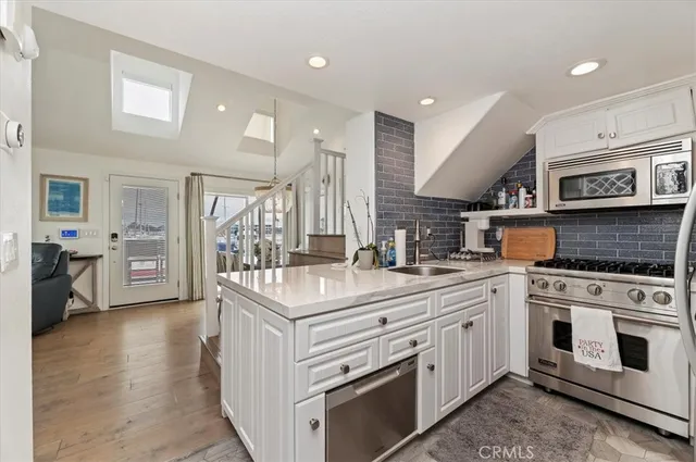 a kitchen with stainless steel appliances granite countertop a stove and cabinets
