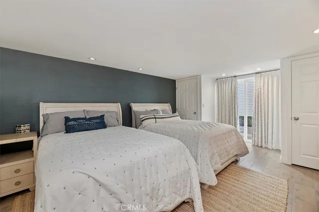 a bedroom with two beds and a dresser