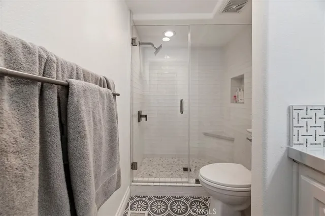 a bathroom with a shower a toilet and a sink