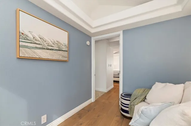 a bedroom with a bed and a painting on the wall