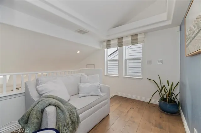 a living room with furniture and potted plant
