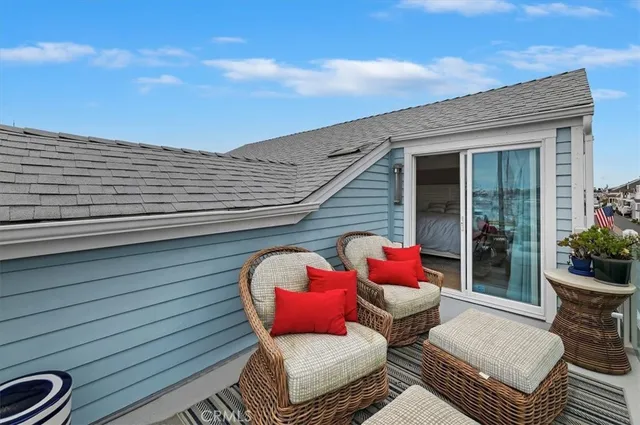 a balcony with furniture and a potted plant