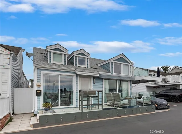 a front view of a building with cars parked