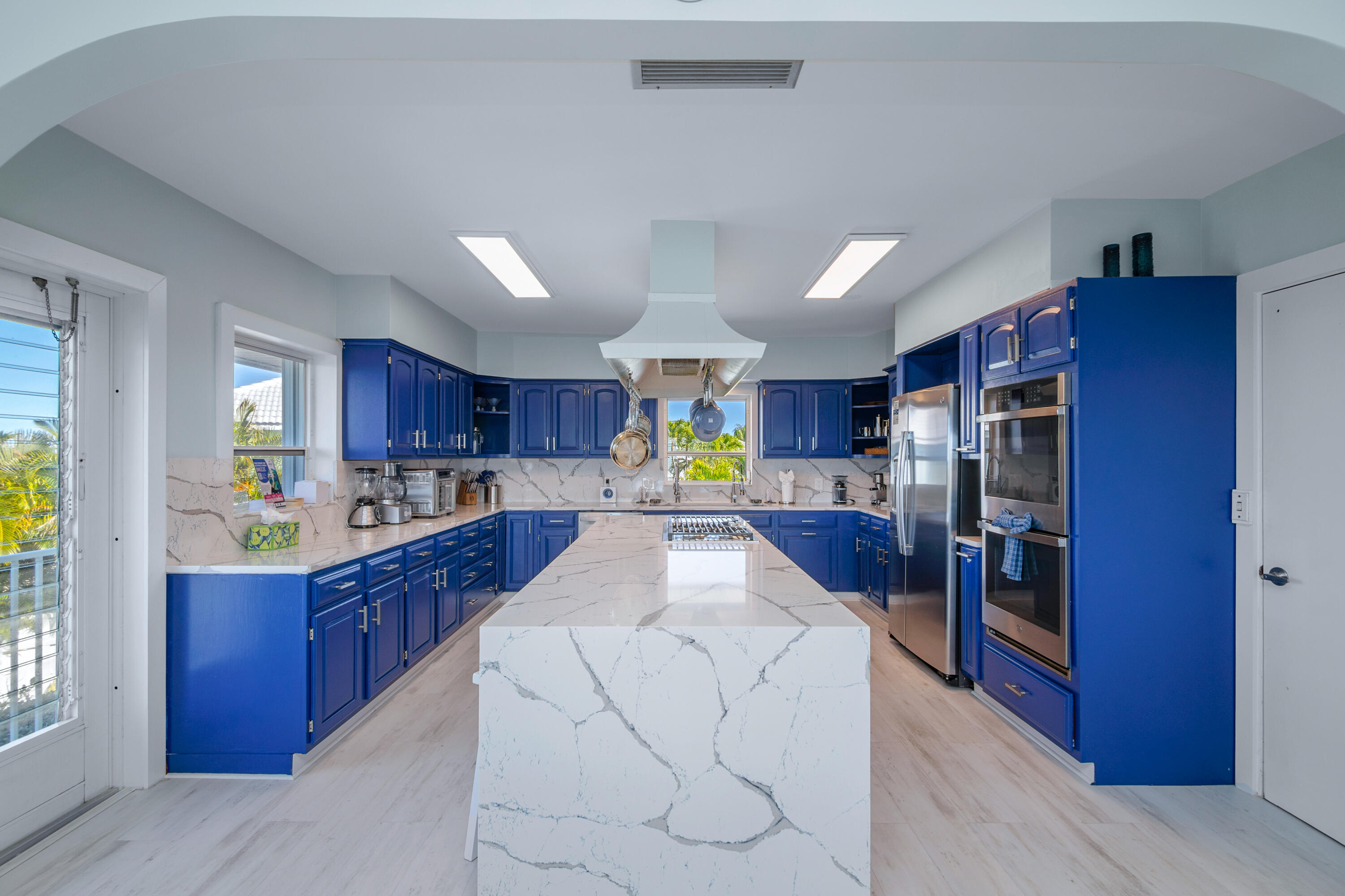 781 9th Street Key Colony Beach, FL 33051 - Photo 17 of 95 a large kitchen with stainless steel appliances kitchen island granite countertop a refrigerator and a stove top oven