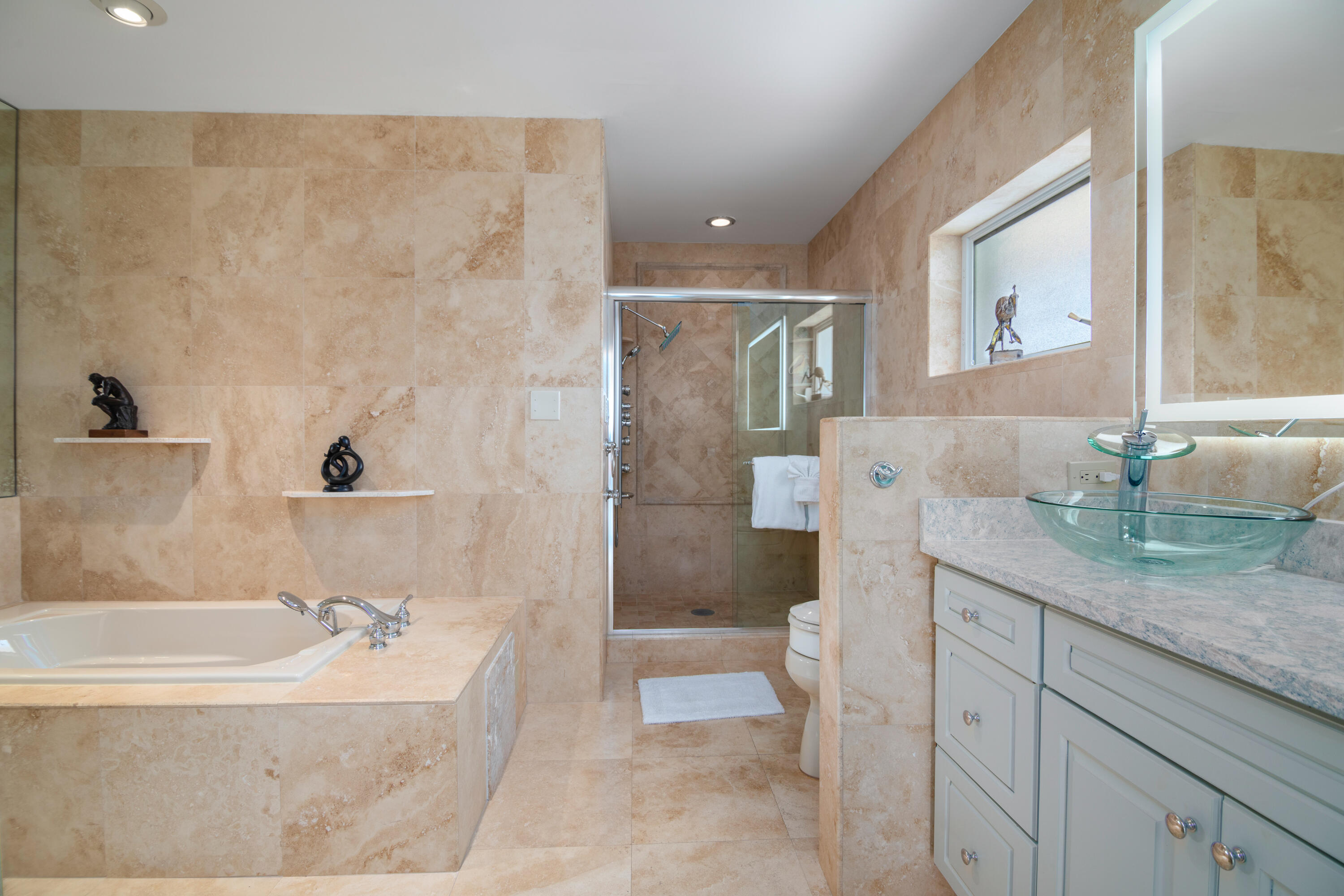 781 9th Street Key Colony Beach, FL 33051 - Photo 34 of 95 a bathroom with a granite countertop sink a mirror a bathtub and shower