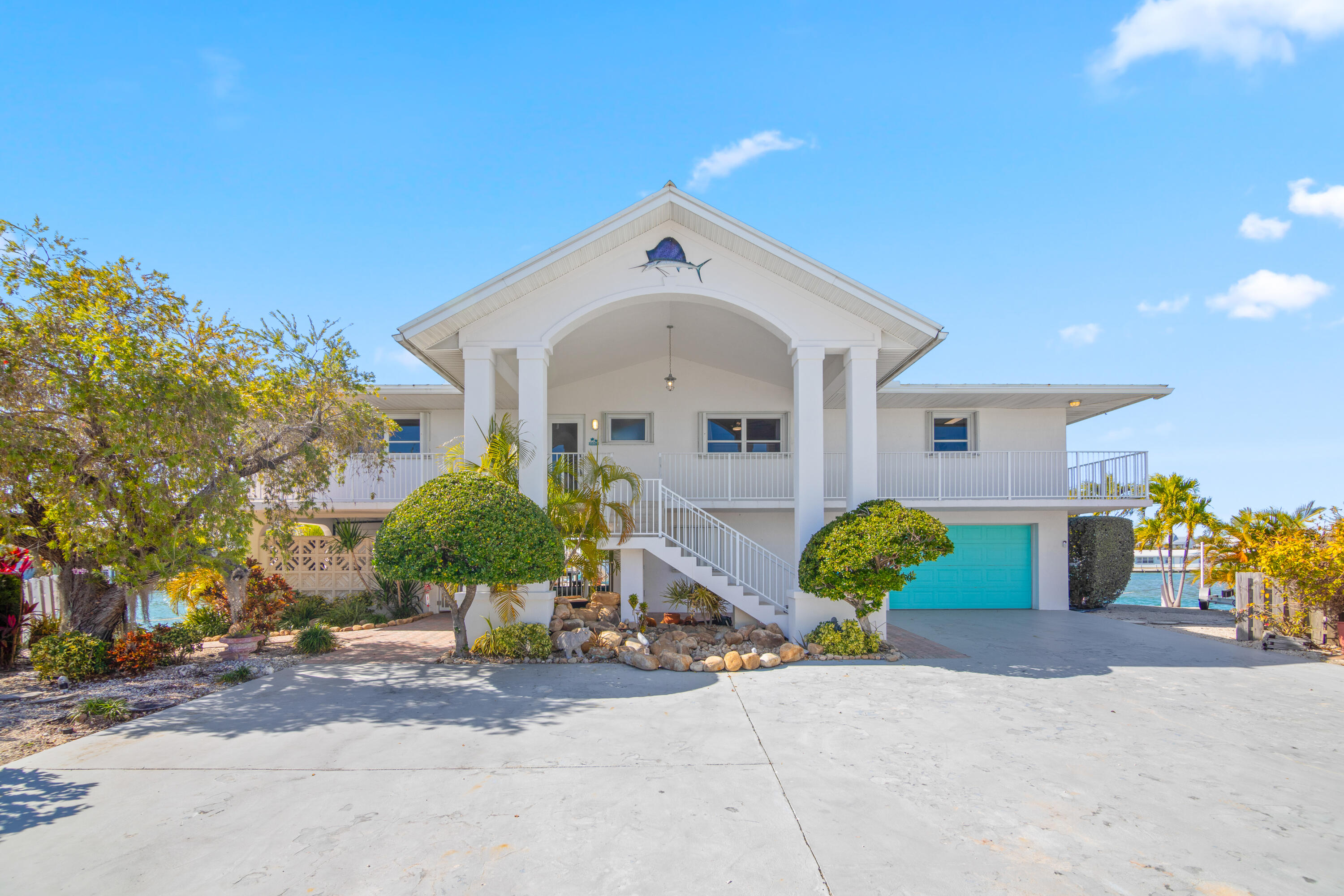 781 9th Street Key Colony Beach, FL 33051 - Photo 46 of 95 a front view of a house with garden
