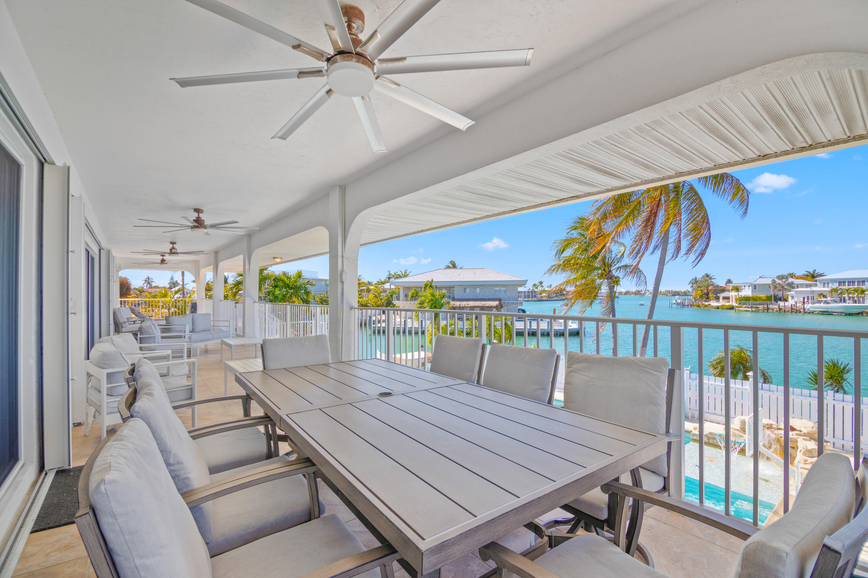 781 9th Street Key Colony Beach, FL 33051 - Photo 48 of 95 a view of a patio with a table and chairs