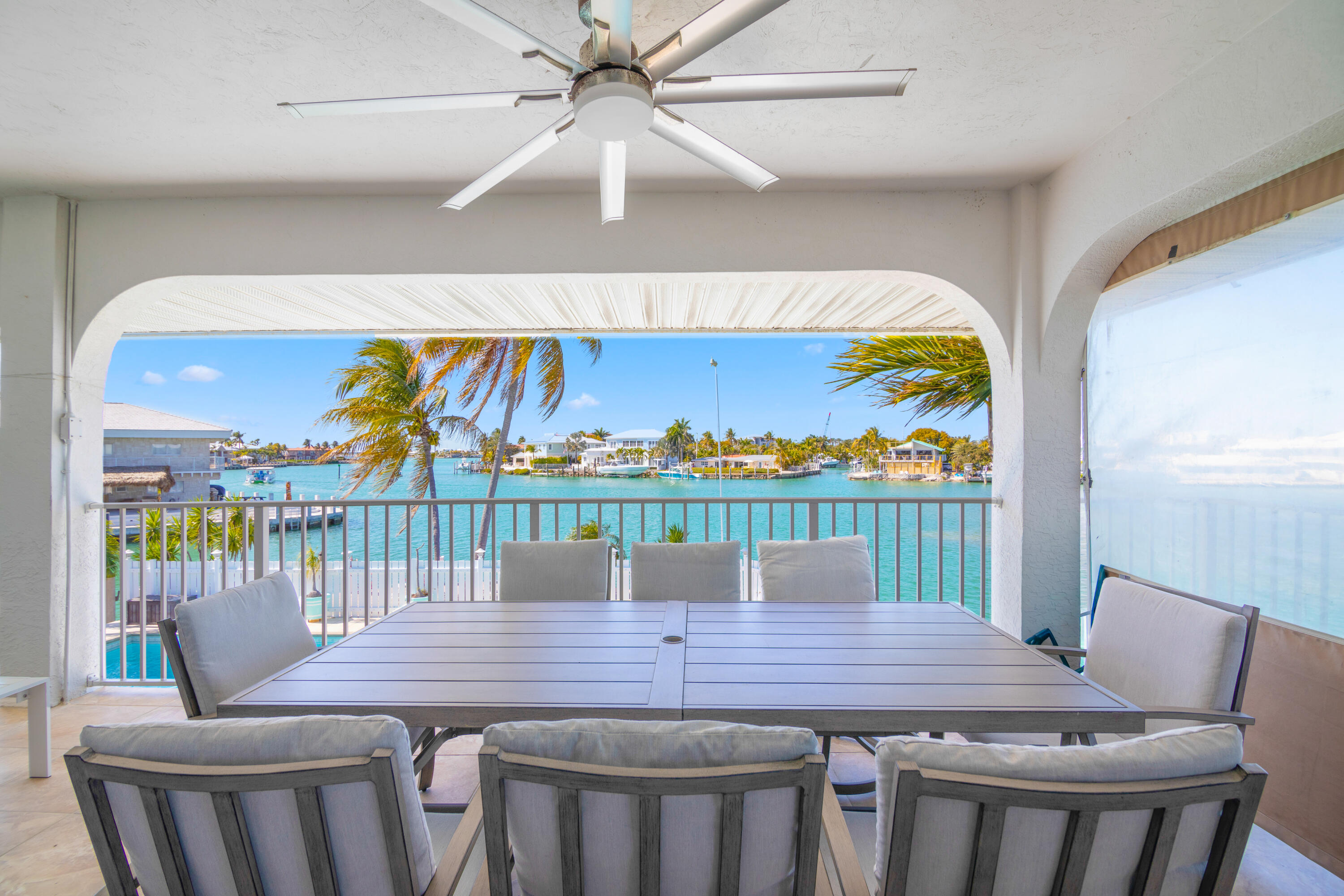 781 9th Street Key Colony Beach, FL 33051 - Photo 49 of 95 a view of a dining room with furniture and a floor to ceiling window