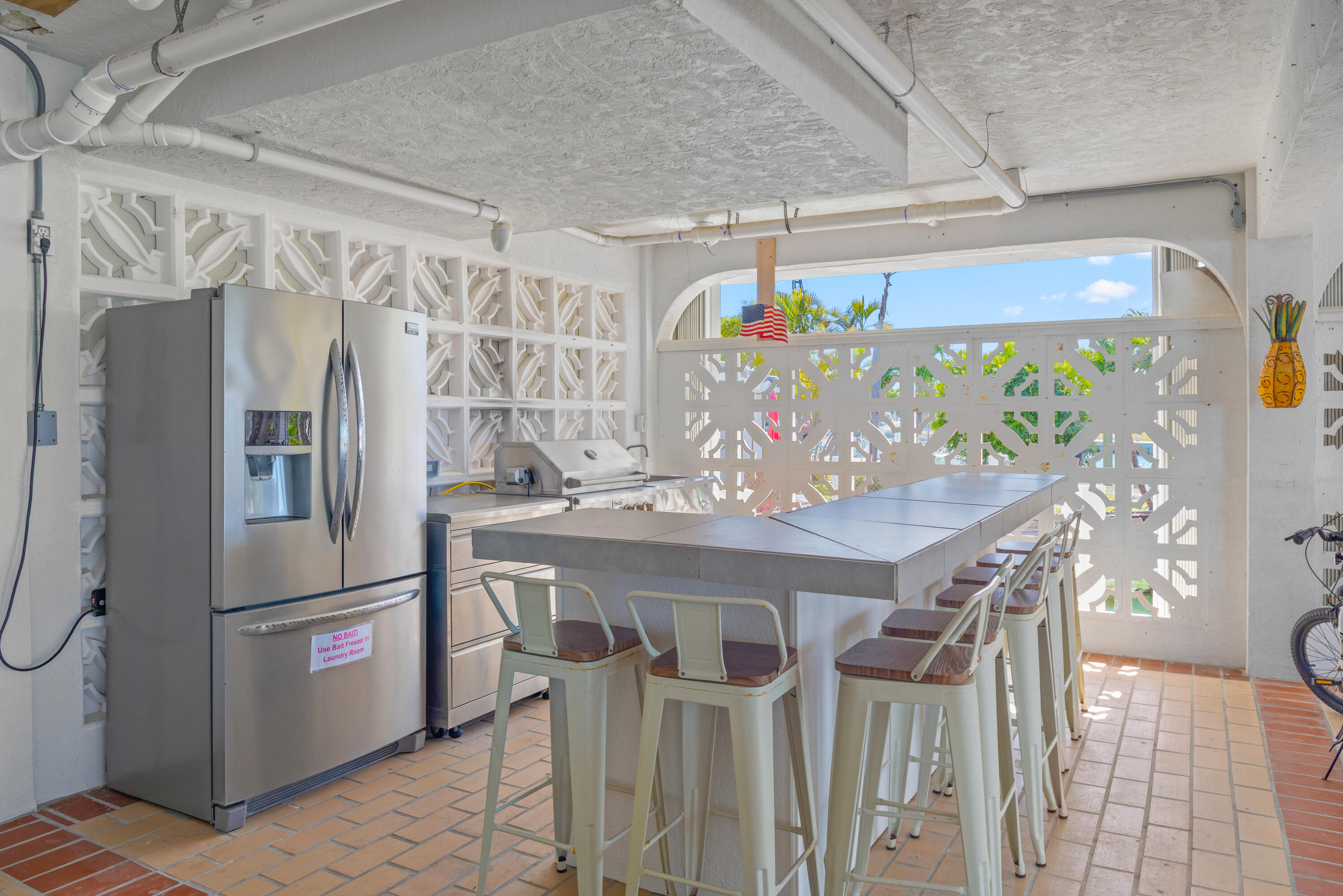 781 9th Street Key Colony Beach, FL 33051 - Photo 64 of 95 a kitchen with stainless steel appliances granite countertop a refrigerator and a table